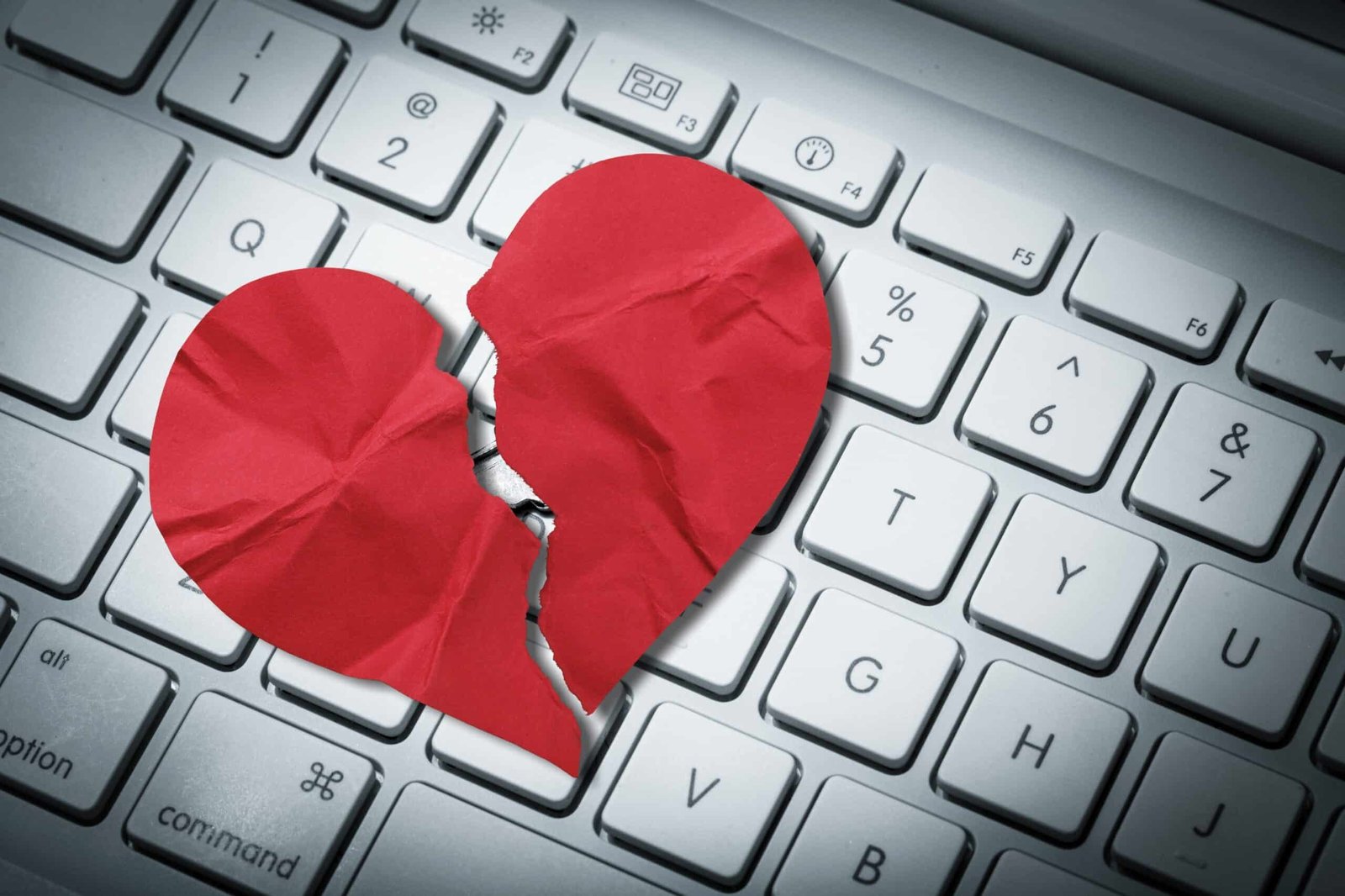 Red heart paper on keyboard computer background. Online internet