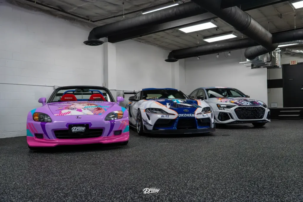 Wrapped cars lined up on the Dream Auto Garage shop floor