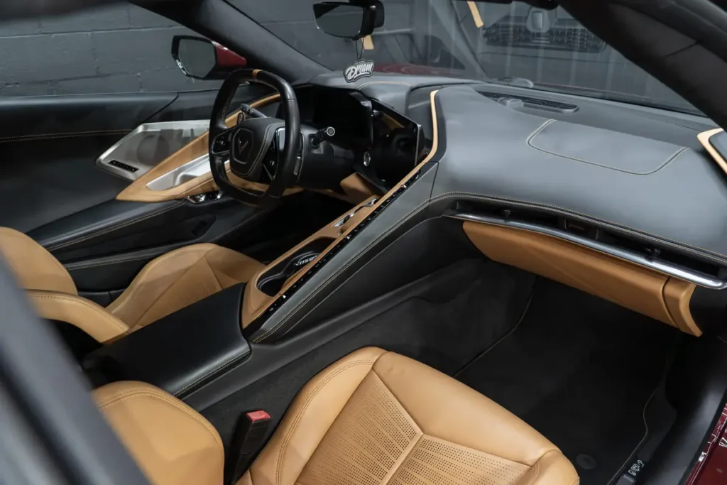 Tan leather seats and dash of a Corvette C8 after an interior detail