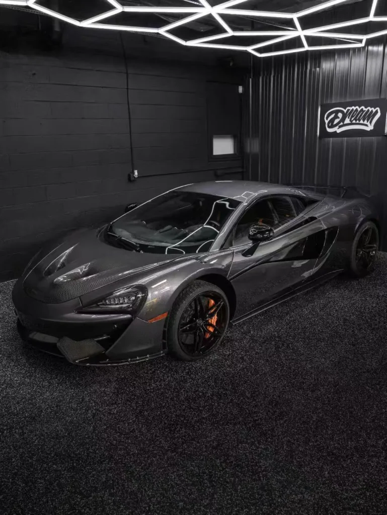 Dark McLaren in the bay after PPF and ceramic coating