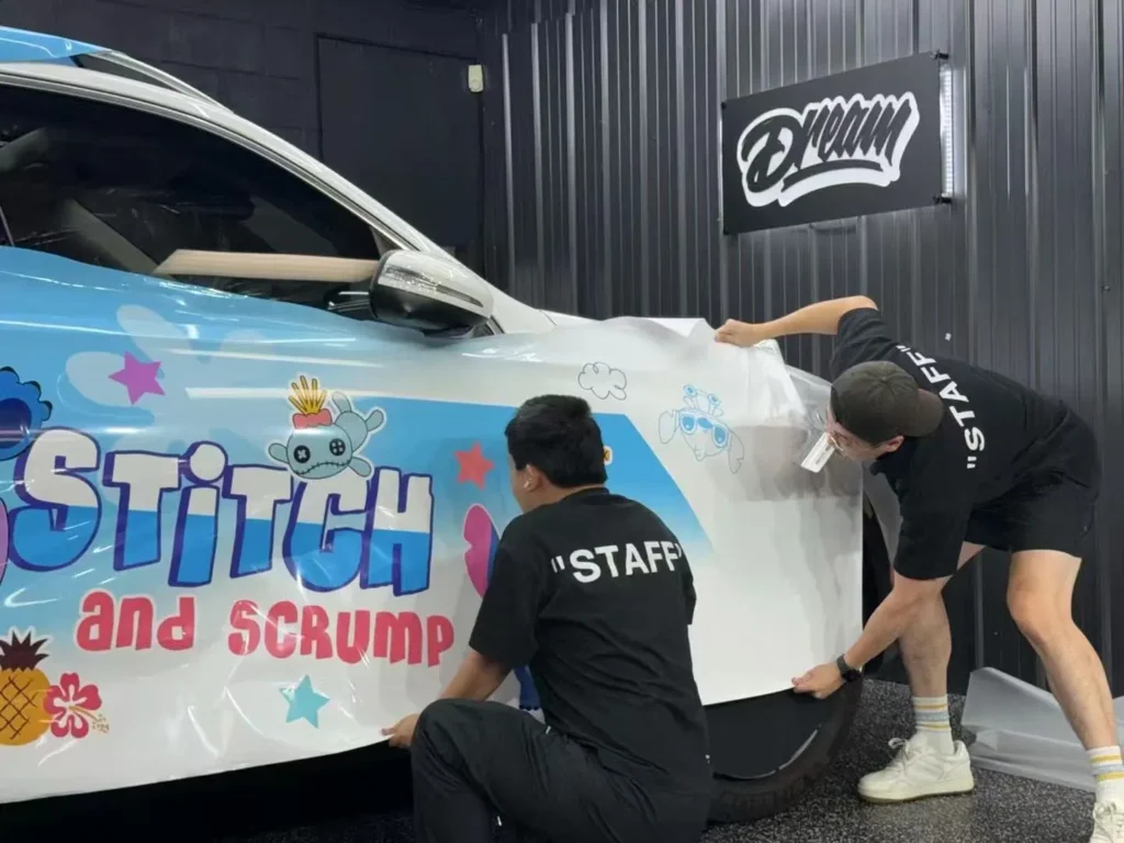 Two technicians applying a printed vinyl wrap