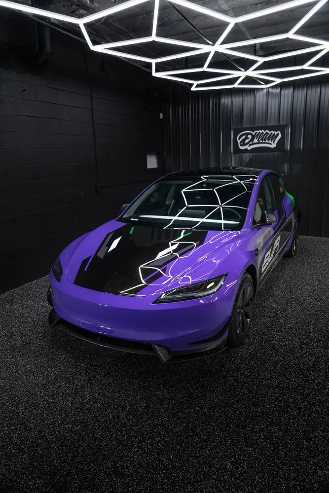 Tesla with a purple EVA-inspired livery wrap under the hex lights