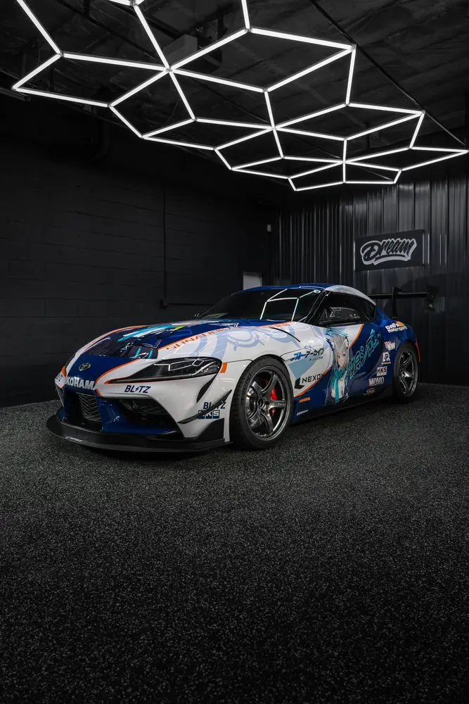Toyota Supra with a white and blue racing livery wrap
