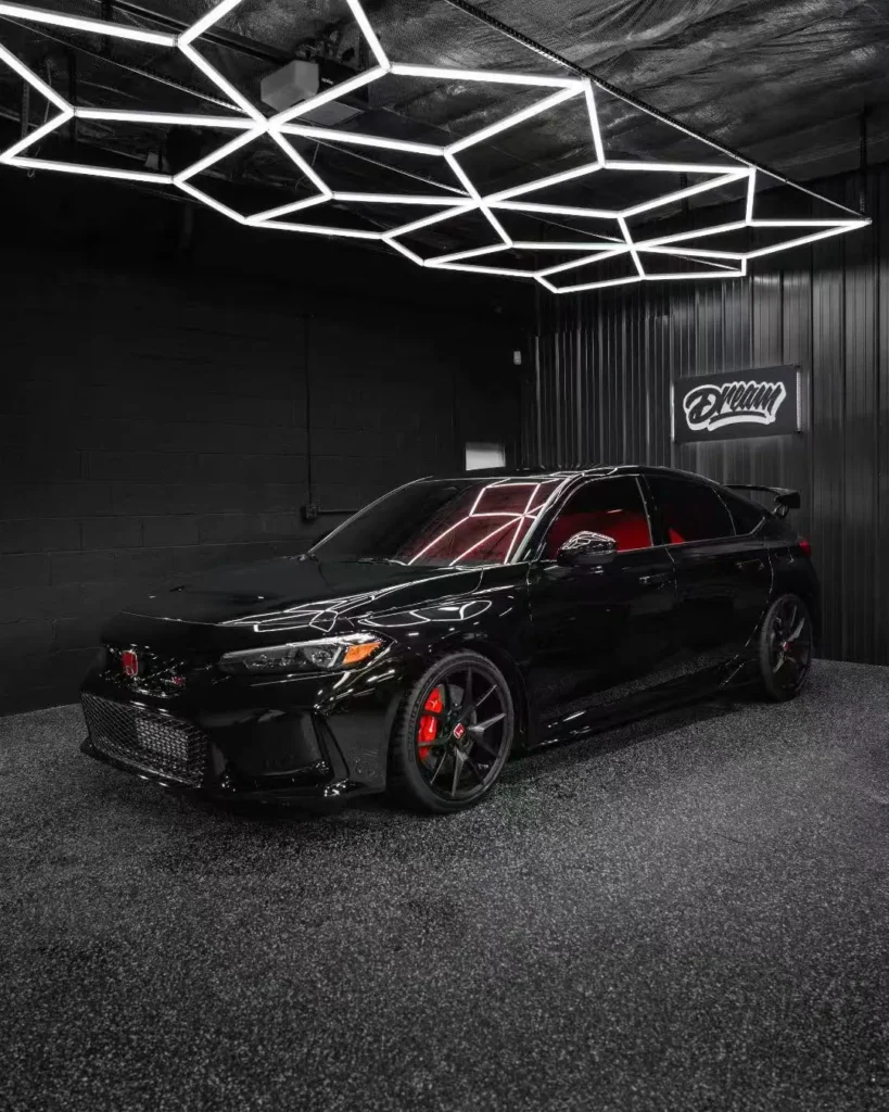 Black Honda Civic under the hex LED ceiling after ceramic coating — Ceramic Coating at Dream Auto Garage, Columbus OH