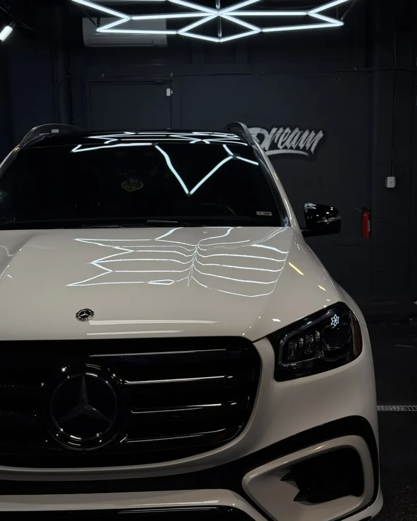 White Mercedes with paint protection film, hex reflections across the hood — PPF at Dream Auto Garage, Columbus OH