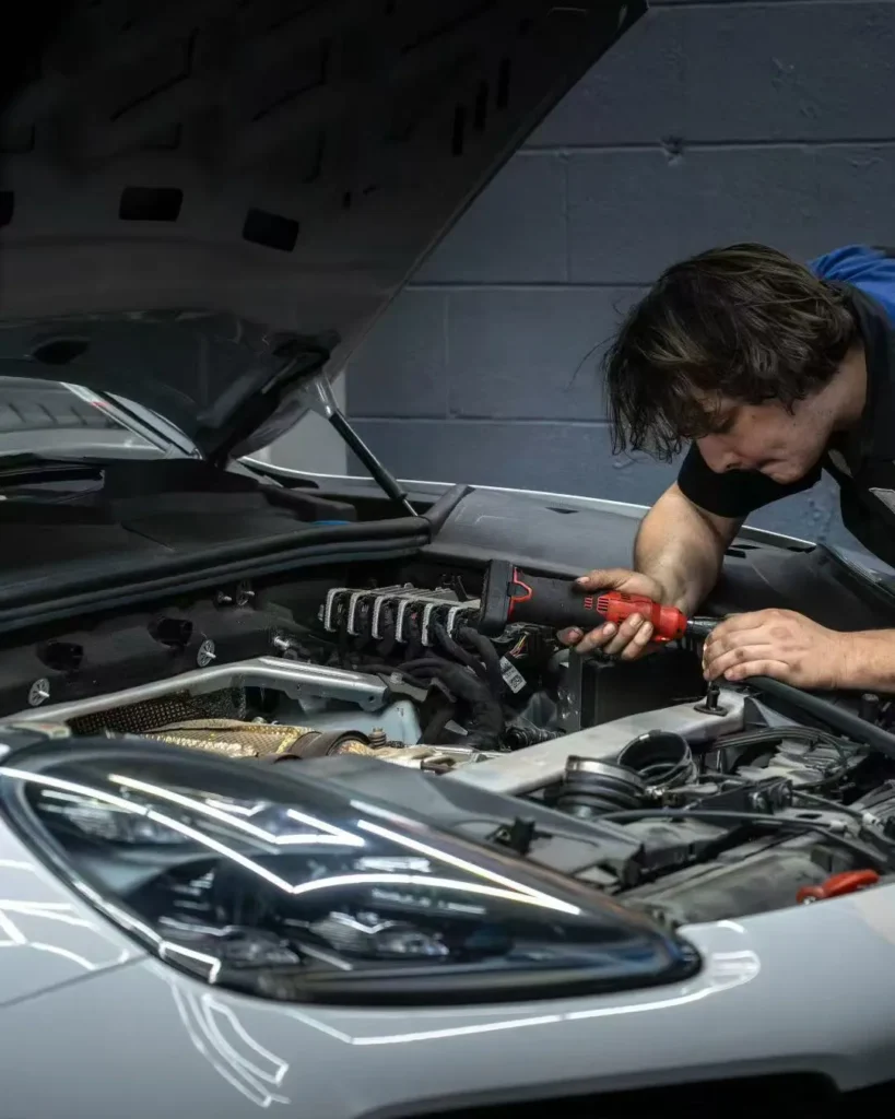 Technician working in an engine bay — Repair & Maintenance at Dream Auto Garage, Columbus OH