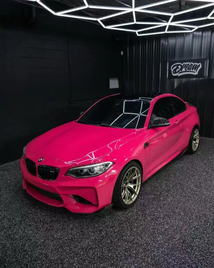 Pink vinyl wrapped BMW M2 in the bay — Vinyl Wrap at Dream Auto Garage, Columbus OH